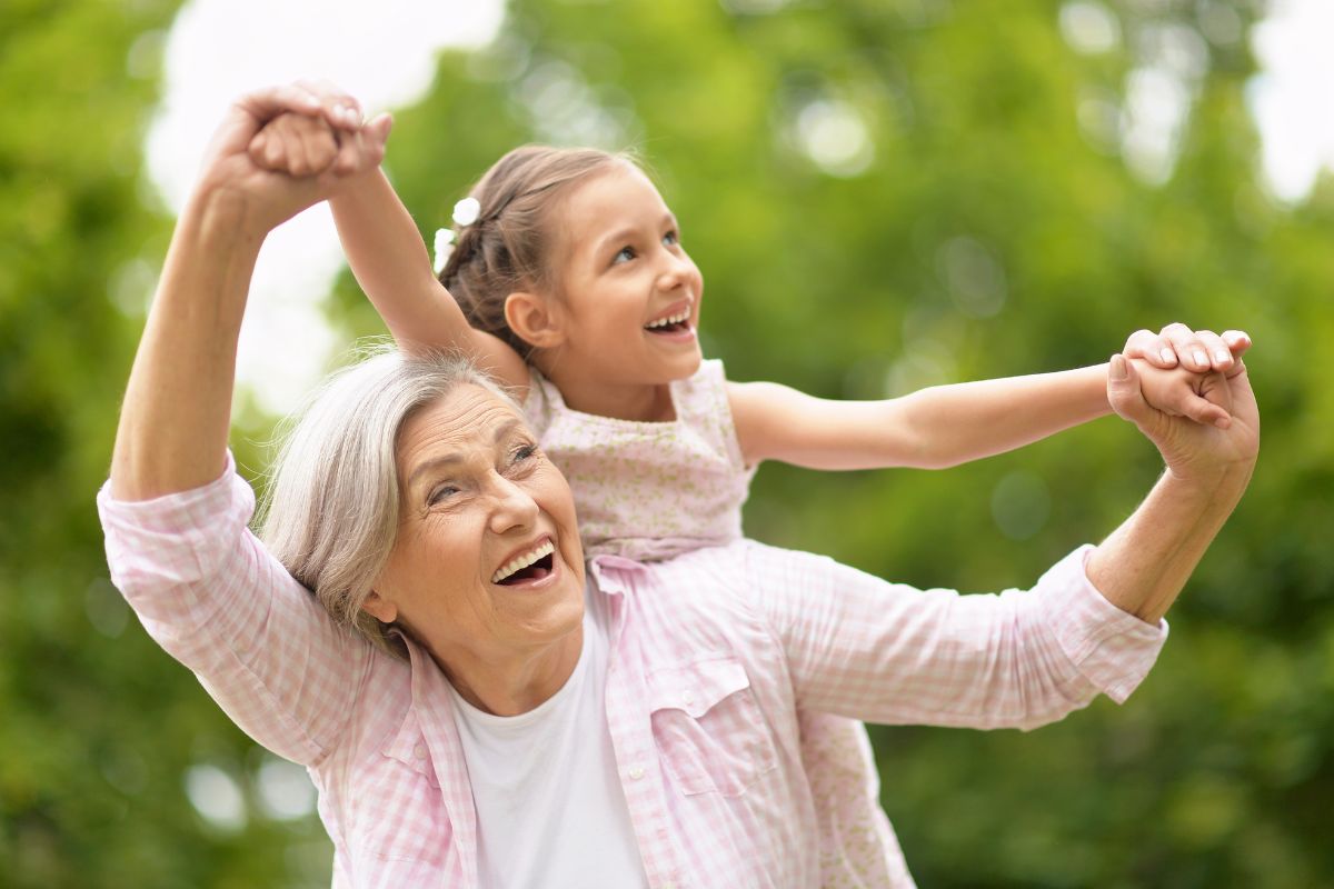 grandmother with grand daughter on her back